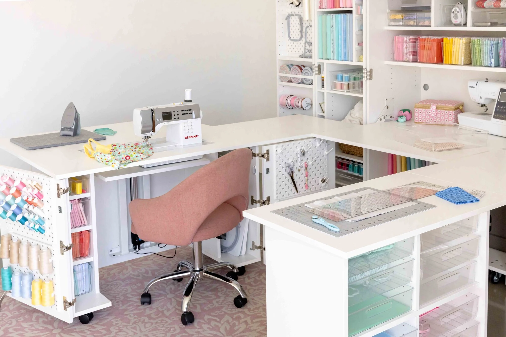 A sewing chair pulled back from a fold-out sewing table, showing extra space behind the chair for standing up and moving comfortably